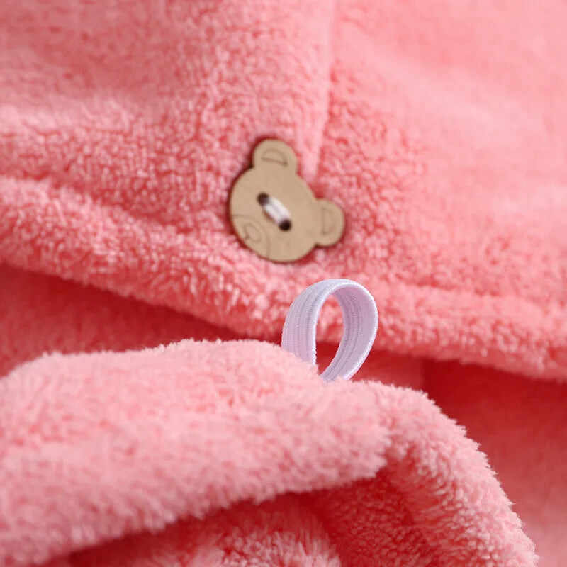 Close-up of pink quick dry microfiber hair towels featuring a bear button for easy handling
