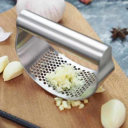 Stainless steel garlic press with ergonomic handle and holes for easy crushing of garlic cloves